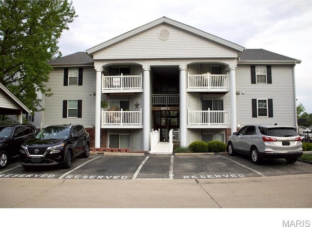 view of building exterior with uncovered parking