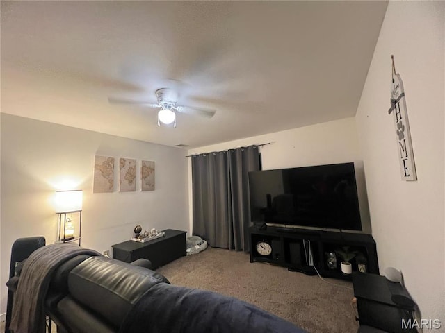 carpeted living area featuring ceiling fan