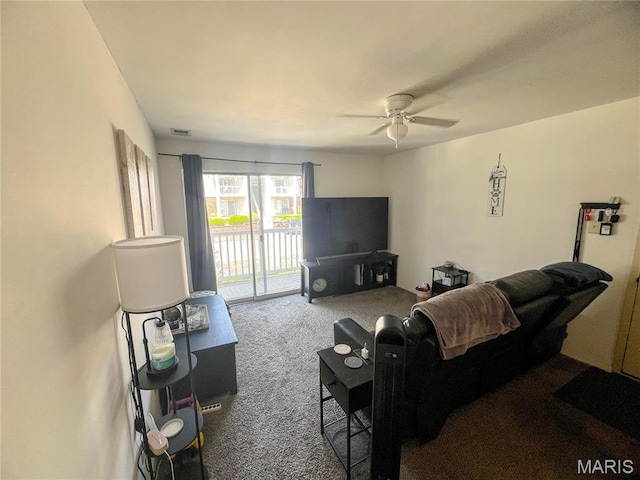 carpeted living room featuring a ceiling fan