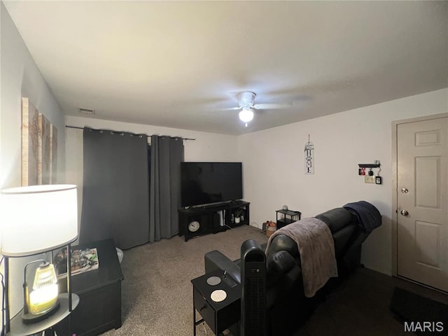 carpeted living room with a ceiling fan
