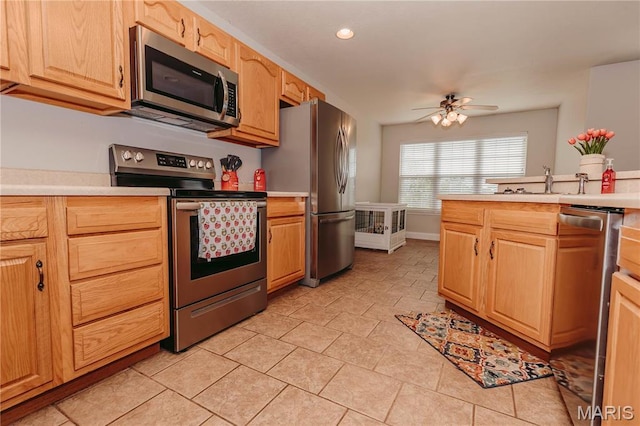 140 Vernon St, Saint Robert, MO 65584 - kitchen featuring stainless steel appliances, light countertops, ceiling fan, recessed lighting, and light brown cabinets
