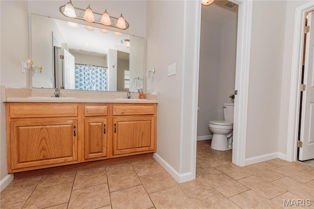 140 Vernon St, Saint Robert, MO 65584 - full bathroom with toilet, double vanity, baseboards, and tile patterned floors