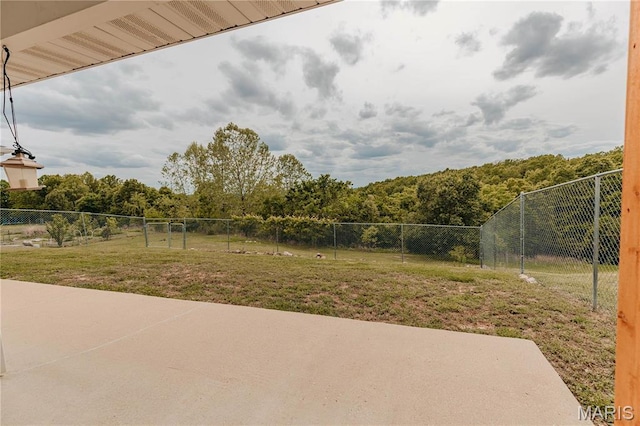 140 Vernon St, Saint Robert, MO 65584 - view of yard featuring a patio and a wooded view