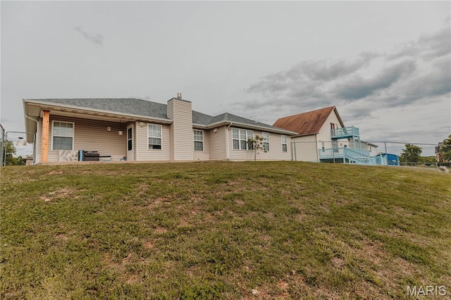 140 Vernon St, Saint Robert, MO 65584 - back of house featuring a chimney and a lawn