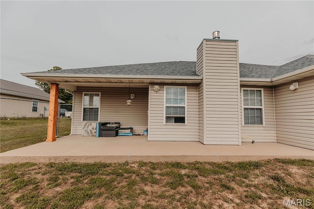 140 Vernon St, Saint Robert, MO 65584 - back of property featuring a patio area, a lawn, and a chimney