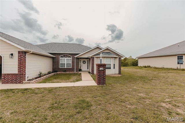 140 Vernon St, Saint Robert, MO 65584 - view of front of home with brick siding, a front yard, and a shingled roof