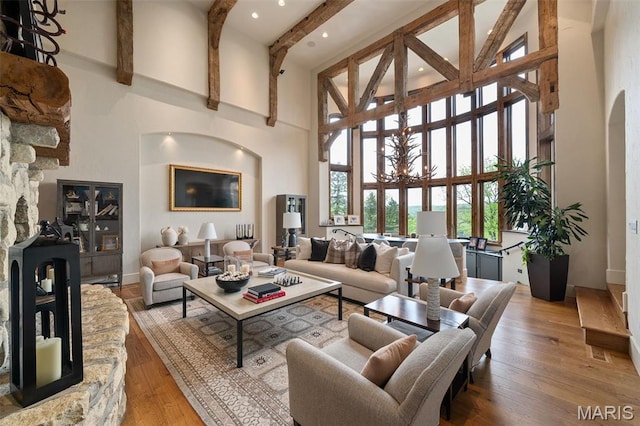 544 Quail Ridge Ln, Saint Albans, MO 63073 - living area with a towering ceiling, beamed ceiling, hardwood / wood-style flooring, baseboards, and a chandelier