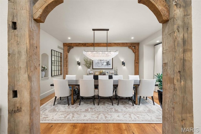544 Quail Ridge Ln, Saint Albans, MO 63073 - dining space featuring arched walkways, wood finished floors, a chandelier, and recessed lighting
