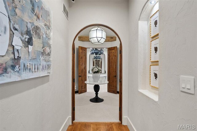 544 Quail Ridge Ln, Saint Albans, MO 63073 - corridor with arched walkways, wood finished floors, and baseboards