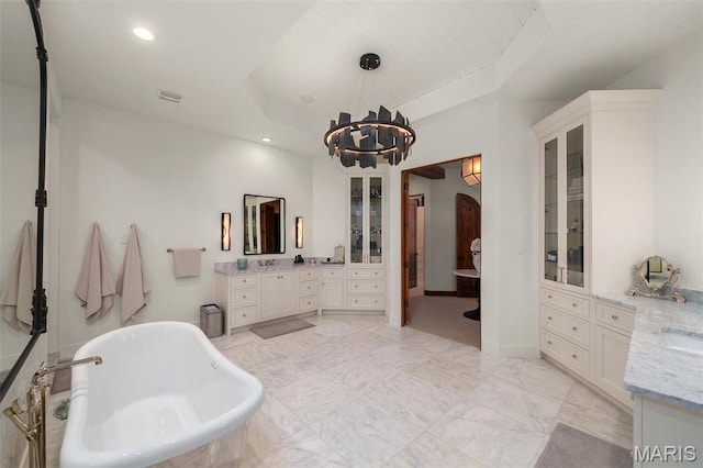 544 Quail Ridge Ln, Saint Albans, MO 63073 - bathroom with a raised ceiling, a soaking tub, two vanities, a chandelier, and recessed lighting