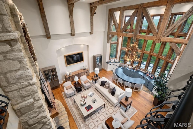 544 Quail Ridge Ln, Saint Albans, MO 63073 - living area featuring high vaulted ceiling, wood finished floors, baseboards, and beam ceiling