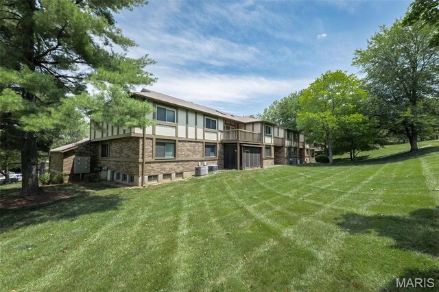2317 Seven Pines Dr Unit 4, Saint Louis, MO 63146 - rear view of house featuring a yard and central AC unit