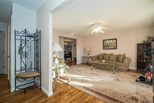 11518 Galba Dr, Florissant, MO 63033 - living area featuring ceiling fan, wood finished floors, and baseboards