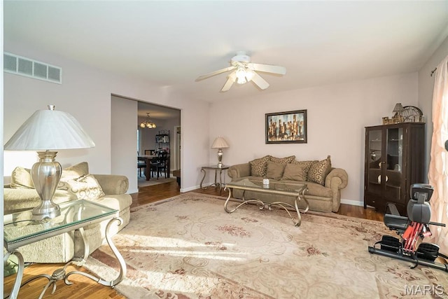 11518 Galba Dr, Florissant, MO 63033 - living room featuring wood finished floors, ceiling fan, and baseboards