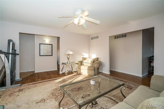 11518 Galba Dr, Florissant, MO 63033 - living area featuring wood finished floors, ceiling fan, and baseboards