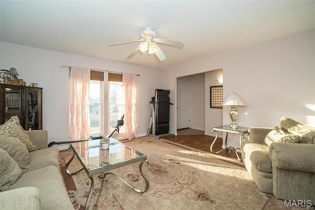 11518 Galba Dr, Florissant, MO 63033 - living room with ceiling fan, baseboards, and wood finished floors
