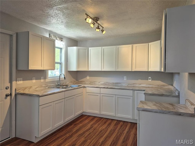 3308 Kendall Ave, Alton, IL 62002 - kitchen featuring a sink, dark wood finished floors, a textured ceiling, light countertops, and white cabinetry
