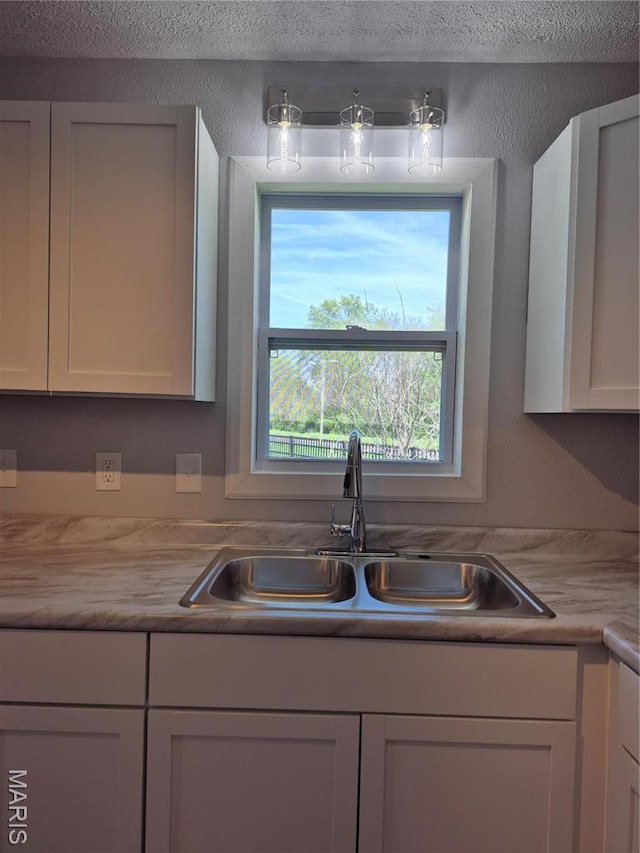 3308 Kendall Ave, Alton, IL 62002 - kitchen featuring a sink, light countertops, and white cabinets