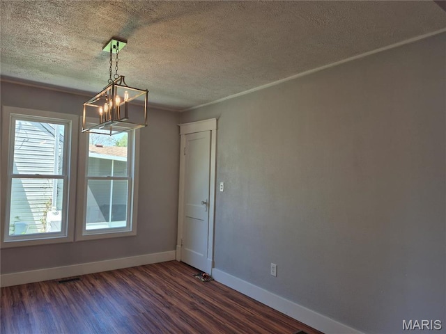 3308 Kendall Ave, Alton, IL 62002 - unfurnished dining area featuring a chandelier, dark wood-style floors, baseboards, and a textured ceiling