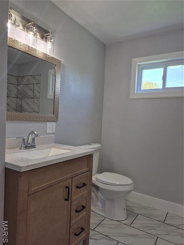 3308 Kendall Ave, Alton, IL 62002 - bathroom featuring marble finish floors, vanity, toilet, and baseboards