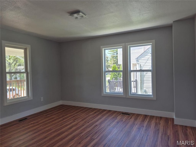 3308 Kendall Ave, Alton, IL 62002 - unfurnished room with dark wood-style flooring, baseboards, and a textured ceiling