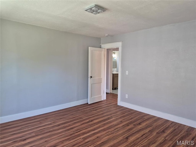 3308 Kendall Ave, Alton, IL 62002 - spare room featuring dark wood-type flooring, baseboards, and a textured ceiling