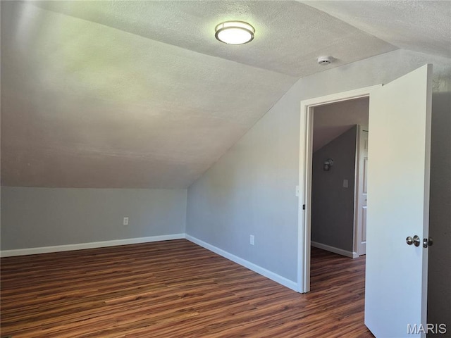 3308 Kendall Ave, Alton, IL 62002 - bonus room featuring lofted ceiling, dark wood finished floors, a textured ceiling, and baseboards