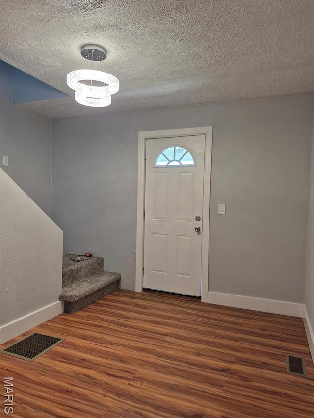 3308 Kendall Ave, Alton, IL 62002 - entryway with wood finished floors, baseboards, a textured ceiling, and stairs
