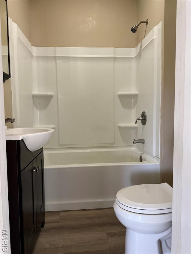 full bath with wood finished floors, toilet, tub / shower combination, and vanity