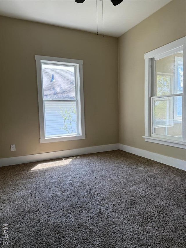 spare room featuring carpet, a ceiling fan, and baseboards
