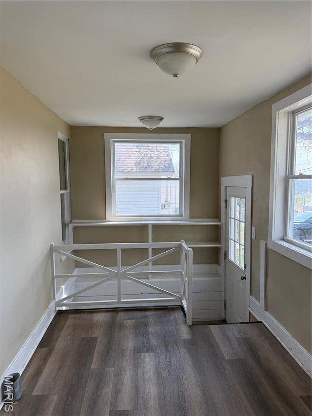doorway to outside with wood finished floors and baseboards