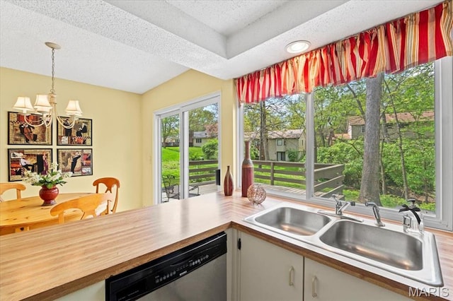889 Almond Hill Ct, Manchester, MO 63021 - kitchen with dishwasher, a sink, a chandelier, pendant lighting, and a textured ceiling