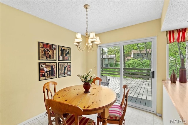 889 Almond Hill Ct, Manchester, MO 63021 - dining room featuring a chandelier, a textured ceiling, and baseboards