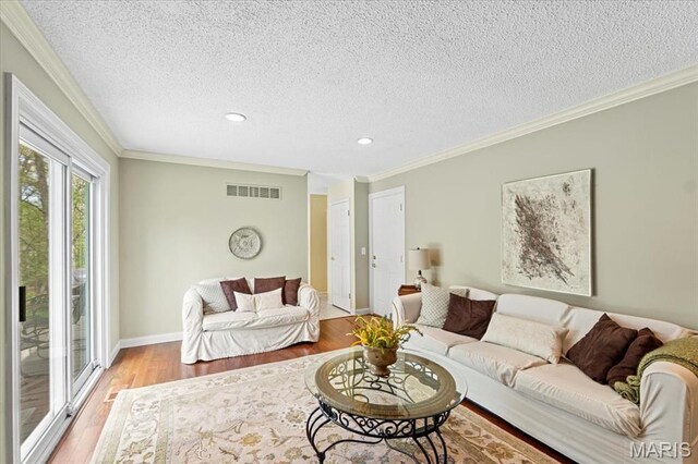 889 Almond Hill Ct, Manchester, MO 63021 - living area with light wood-style floors, a textured ceiling, recessed lighting, baseboards, and ornamental molding