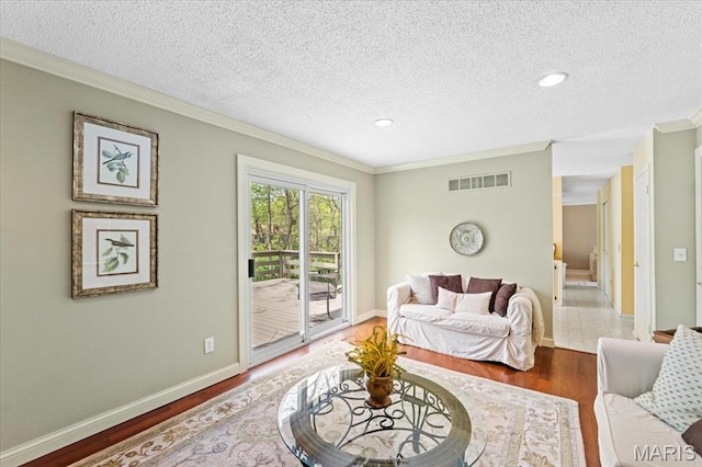 889 Almond Hill Ct, Manchester, MO 63021 - living area with wood finished floors, ornamental molding, a textured ceiling, baseboards, and recessed lighting