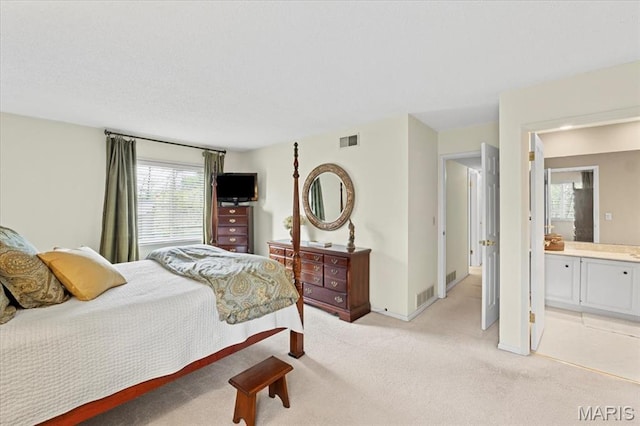 889 Almond Hill Ct, Manchester, MO 63021 - bedroom with multiple windows, light colored carpet, baseboards, and connected bathroom
