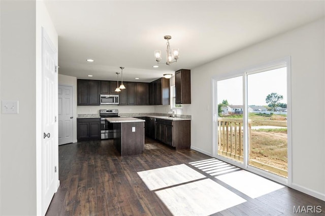 4145 Bear Ridge Dr, House Springs, MO 63051 - kitchen with appliances with stainless steel finishes, dark brown cabinetry, a chandelier, baseboards, and recessed lighting