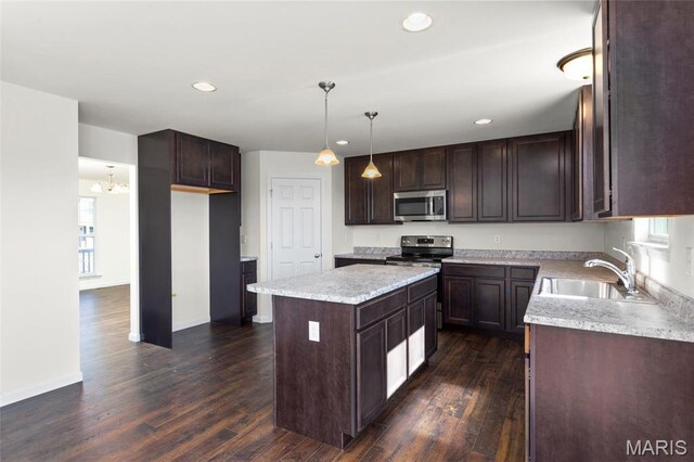 4145 Bear Ridge Dr, House Springs, MO 63051 - kitchen with a sink, stainless steel appliances, dark brown cabinetry, a center island, and dark wood-type flooring