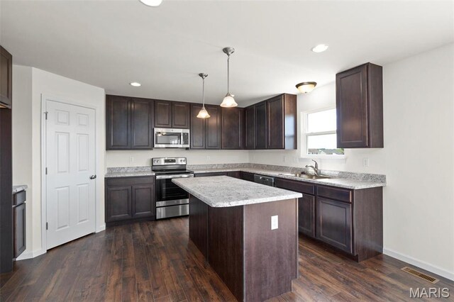 4145 Bear Ridge Dr, House Springs, MO 63051 - kitchen with stainless steel appliances, a sink, dark brown cabinetry, dark wood-style floors, and a center island