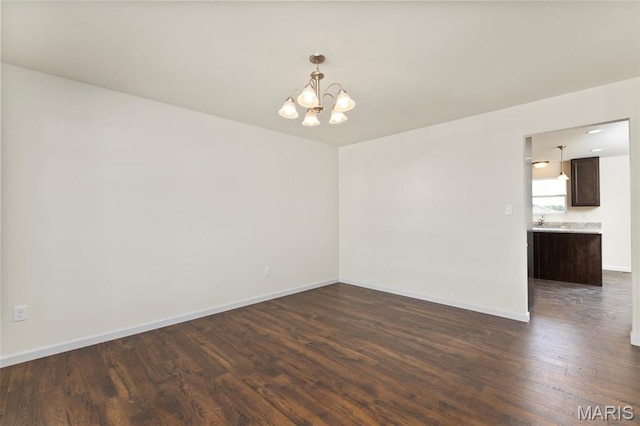 4145 Bear Ridge Dr, House Springs, MO 63051 - empty room with a chandelier, dark wood finished floors, baseboards, and a sink