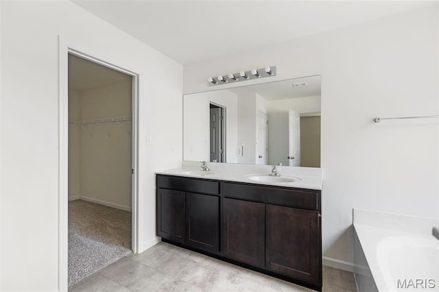 4145 Bear Ridge Dr, House Springs, MO 63051 - full bathroom with a walk in closet, double vanity, a bath, and baseboards