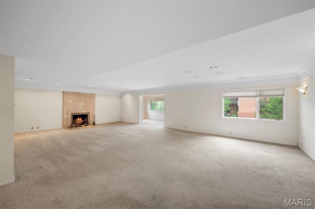 303 N Meramec Ave Unit 202, Saint Louis, MO 63105 - unfurnished living room with light colored carpet, crown molding, recessed lighting, a high end fireplace, and baseboards