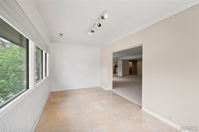 303 N Meramec Ave Unit 202, Saint Louis, MO 63105 - empty room with brick wall, crown molding, and baseboards