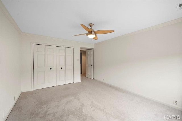 303 N Meramec Ave Unit 202, Saint Louis, MO 63105 - unfurnished bedroom featuring light colored carpet, ornamental molding, a closet, baseboards, and a ceiling fan