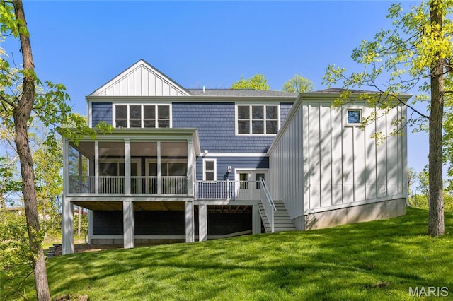 rear view of property with a sunroom, stairway, a yard, and a deck