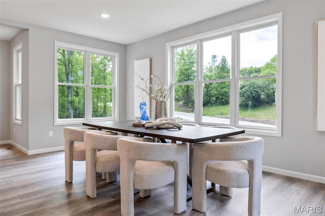 dining room with baseboards, healthy amount of natural light, light wood-type flooring, and recessed lighting