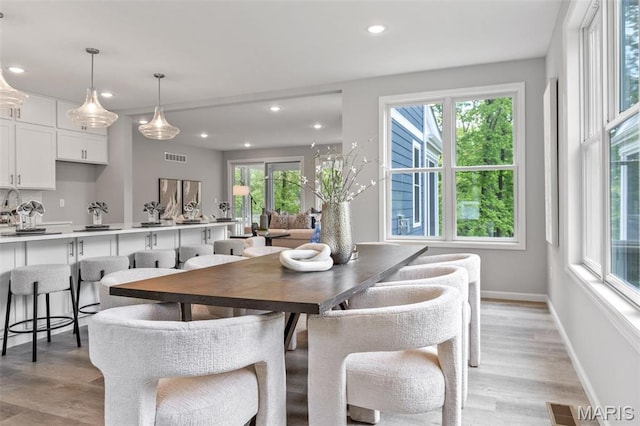 dining space featuring plenty of natural light, light wood-type flooring, recessed lighting, and baseboards