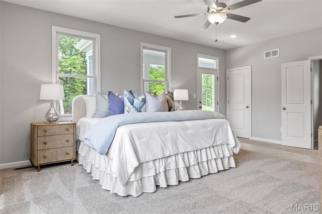 bedroom with multiple windows, baseboards, and carpet