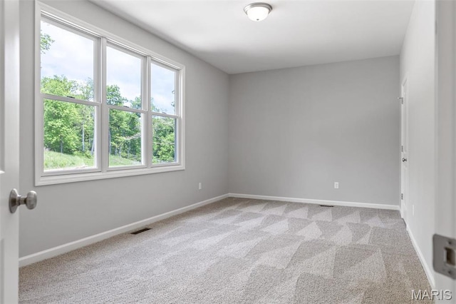 carpeted spare room with baseboards
