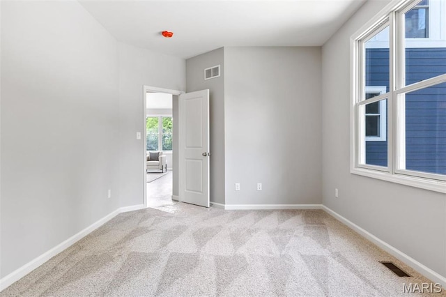 carpeted empty room with baseboards